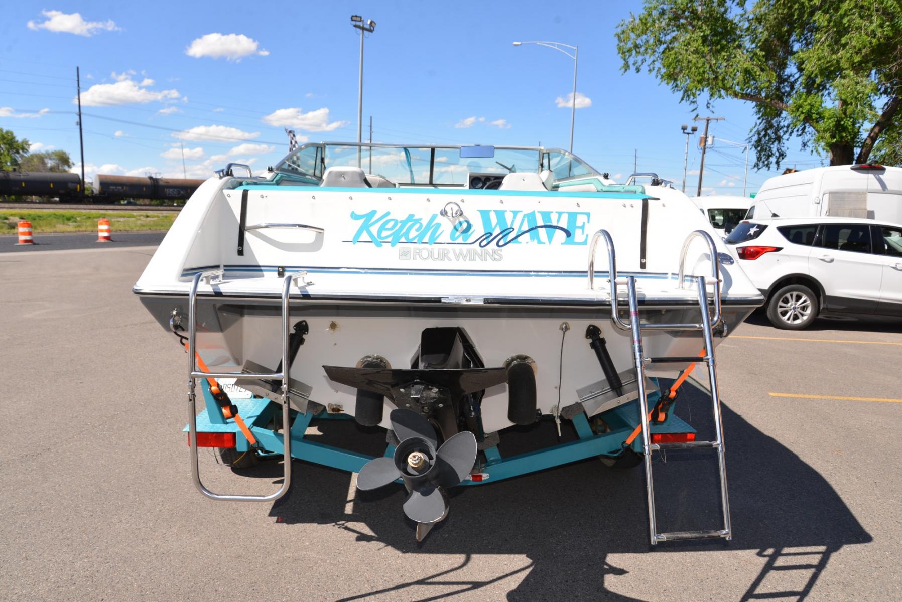 1990 Blue Four Winns Sun Downer (4WNMK149H99) with an 350 Chevy V8 engine, located at 4562 State Avenue, Billings, MT, 59101, (406) 896-9833, 45.769516, -108.526772 - 1990 Four Winns Sundowner 21 Foot Boat with trailer Seats 10 5.7L Chevy V8 OMC Outdrive External Exhaust with tip downs Upholstery was recently redone with 2 captains chairs Boat has had a bow conversion to make it like a runabout 4 swivel type fishing Chairs Tandem Axle Trailer with surge - Photo #7