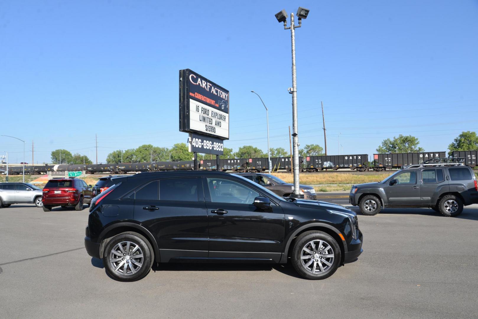 2022 Stellar Black Metallic /Jet Black Cadillac XT4 Sport AWD (1GYFZFR40NF) with an 2.0L L4 DOHC 16V engine, 9A transmission, located at 4562 State Avenue, Billings, MT, 59101, (406) 896-9833, 45.769516, -108.526772 - This Cadillac has remaining factory warranty, only 15,124 miles, and was a local trade-in. It is a two-owner SUV with no accidents reported on the history report. The Cadillac is in excellent condition. The tires are 18-inch Continental ProContact TX, and they are in good condition. Engine: 2.0L - Photo#1